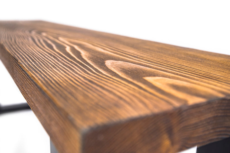 Brown wooden spruce bench with a simple, natural design and sturdy legs, perfect for adding rustic charm to any space