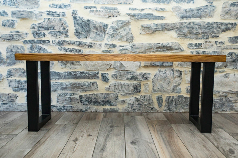 Brown wooden spruce bench with a simple, natural design and sturdy legs, perfect for adding rustic charm to any space