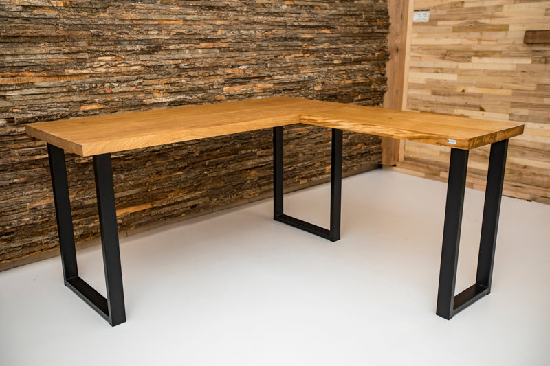 Industrial style corner office desk with a metal frame and wooden top, featuring a minimalist design and spacious work surface.