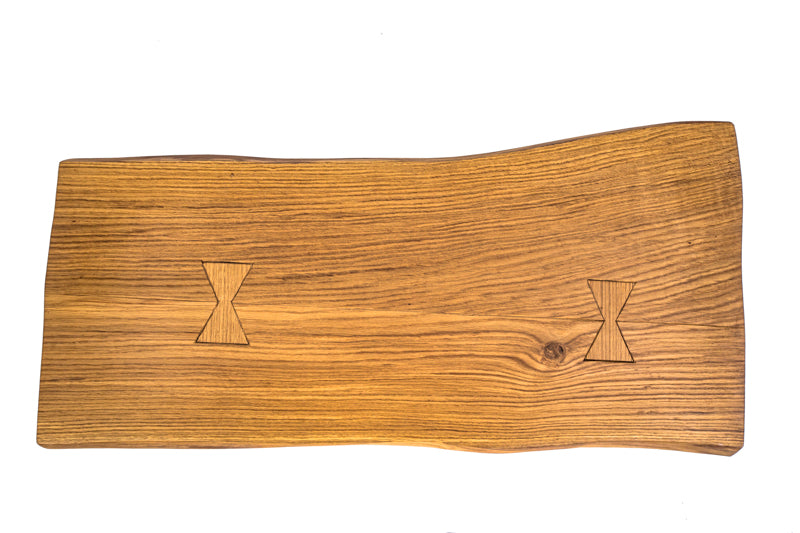 Live edge hairpin oak coffee table with a natural wood finish and sleek metal legs, combining rustic and modern styles.