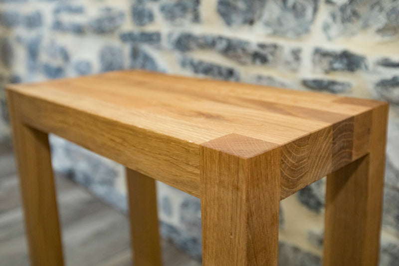 Natural oak bench with a sleek, minimalist design, perfect for adding warmth and style to any room or entryway.