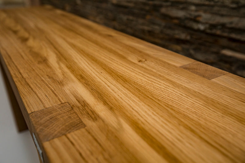 Natural oak rectangle bench with a smooth finish, offering a simple yet elegant seating option for any space.