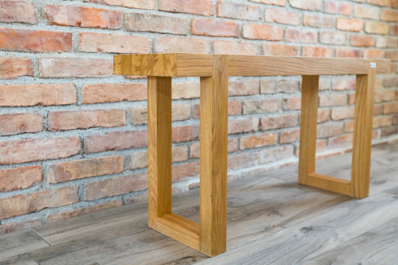 Natural oak rectangle bench with a smooth finish, offering a simple yet elegant seating option for any space.