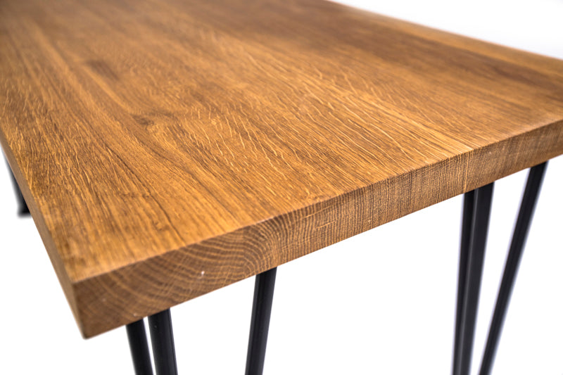 Scandinavian-style hairpin oak dining table with a clean design, natural wood finish, and sleek metal legs for a modern touch.