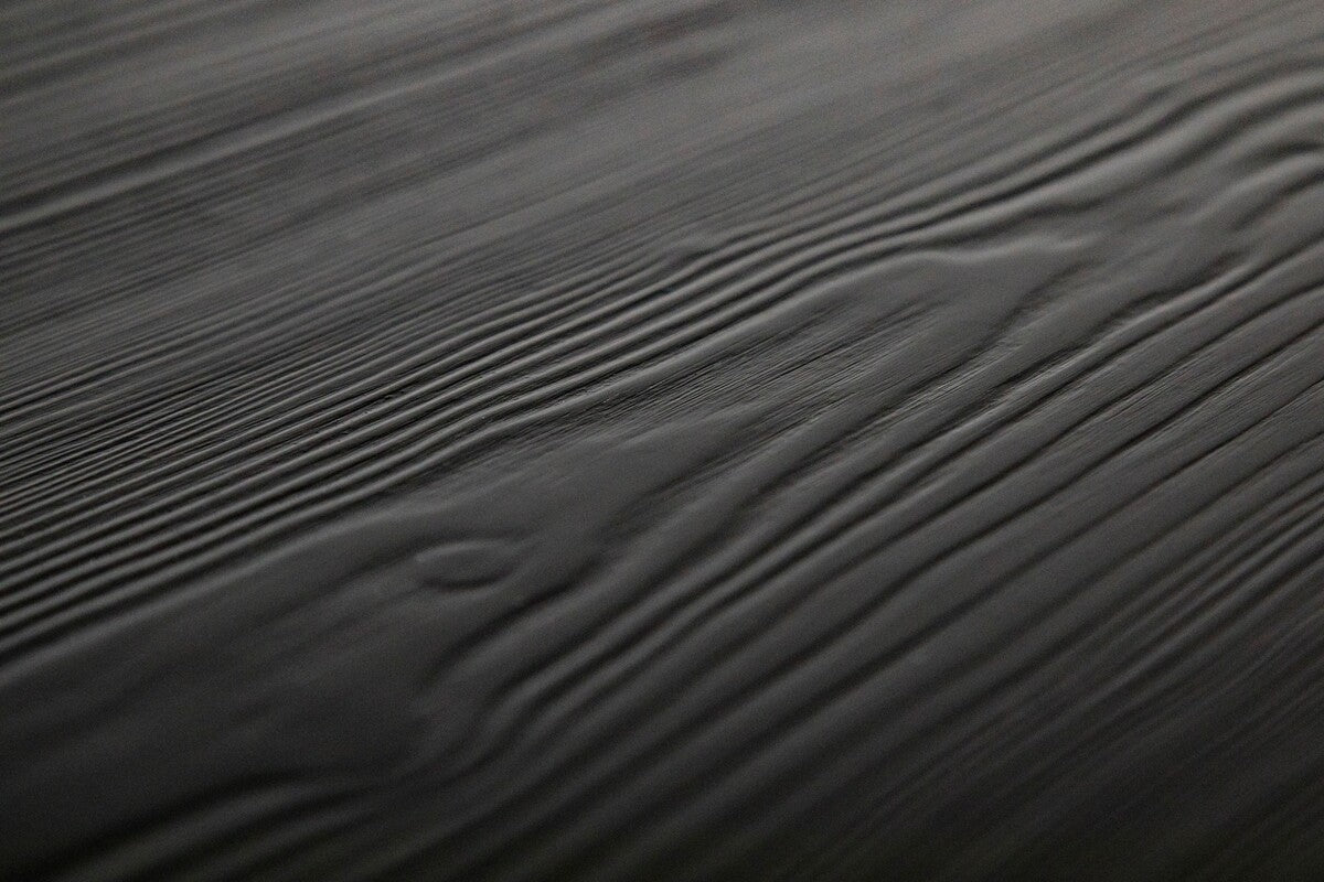 Black spruce desk with a sleek, modern design and spacious surface, perfect for home or office use.