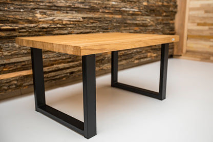 Industrial style oak coffee table with a natural wood surface and metal frame, offering a rustic yet modern look.