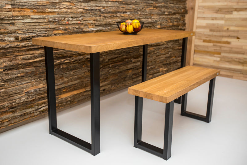 Industrial style oak dining table with a sturdy wood surface and metal frame, blending rustic and modern design elements.