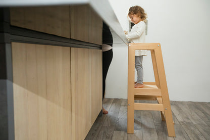 Montessori learning tower with a safe, sturdy design, helping young children reach countertops for independent learning.